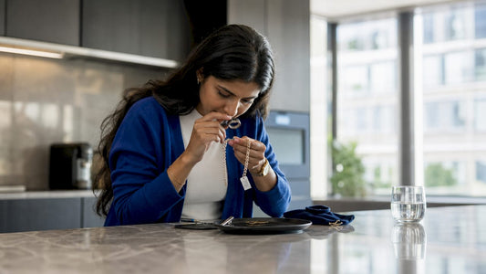 Woman inspecting sterling silver necklace for quality