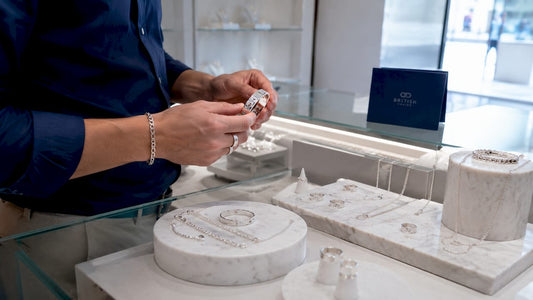Hands examining sterling silver jewellery display