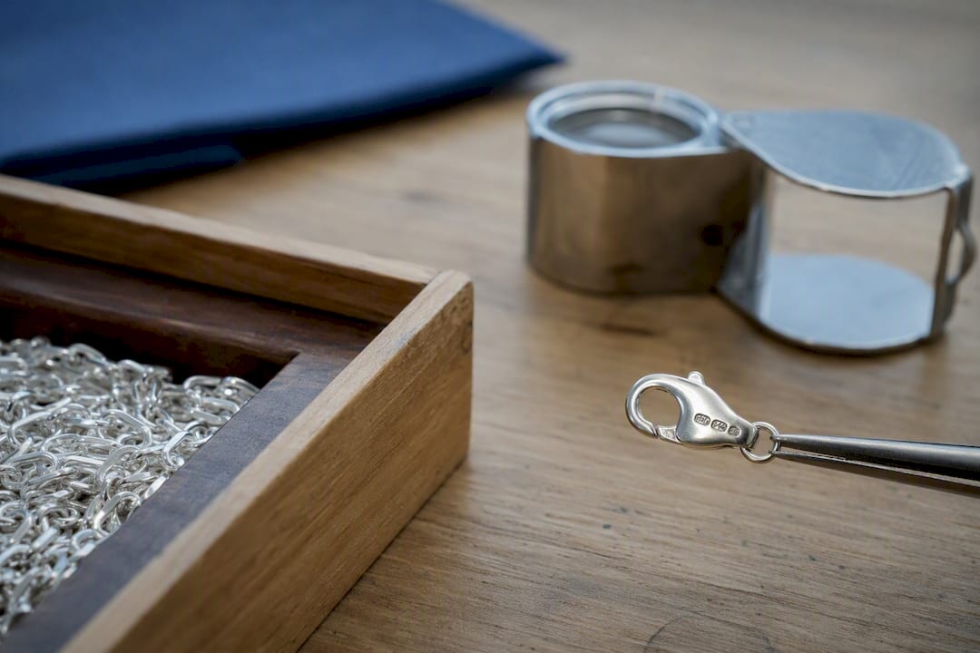 Close-up of sterling silver chain clasp with hallmark