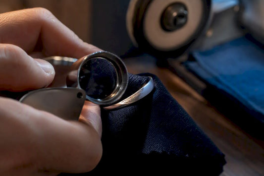 Jeweller inspecting worn rhodium plating