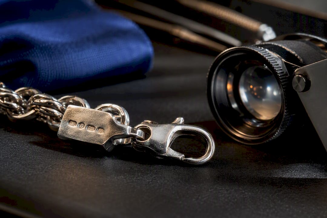 Close-up of hallmark on silver chain clasp