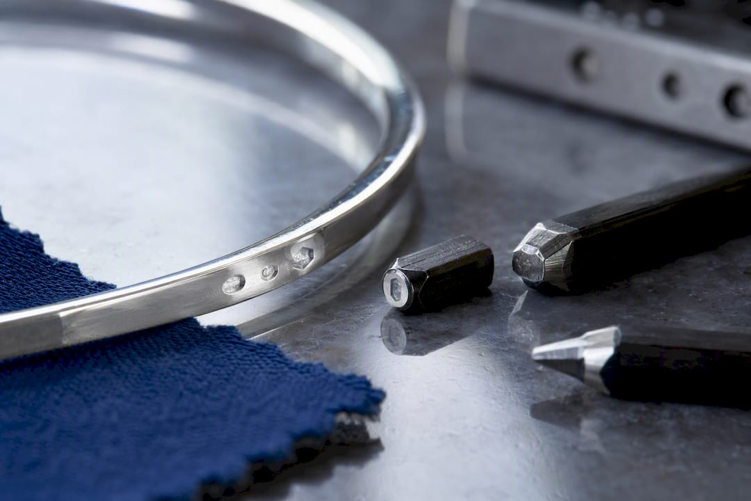 Close-up of silver stamp and assay punches