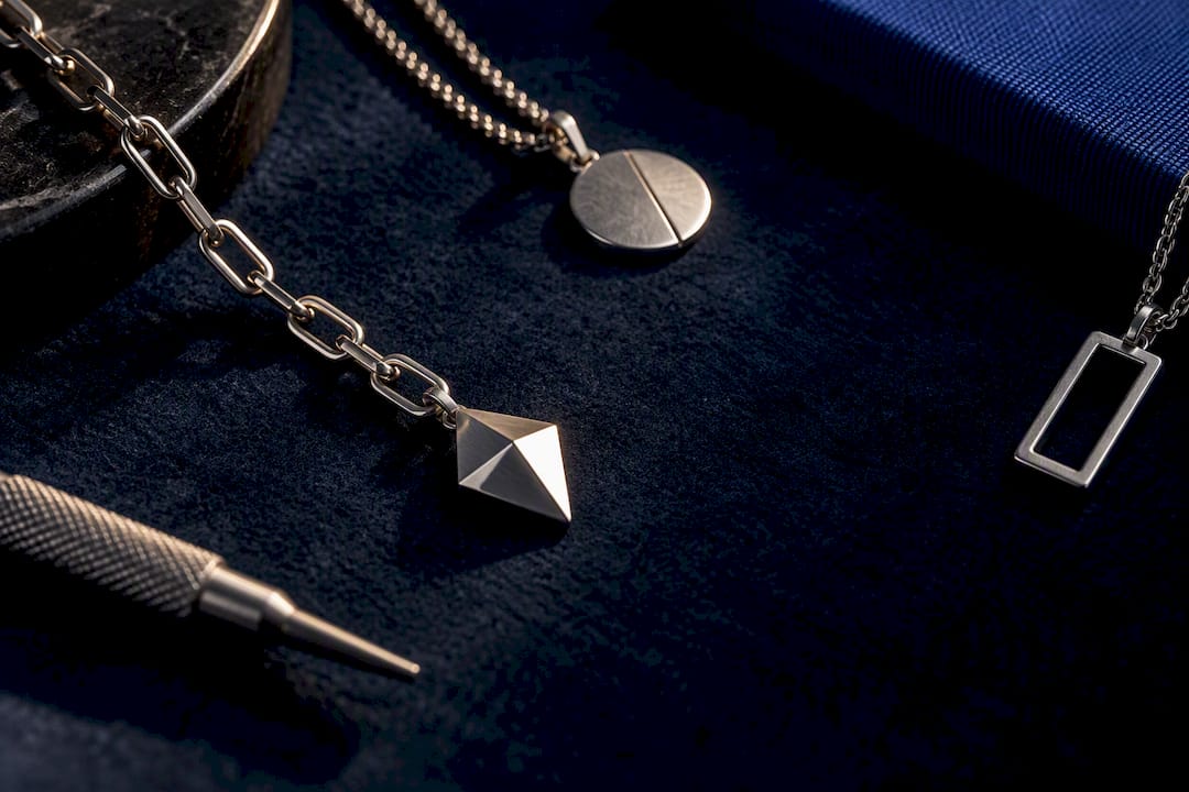 Silver necklace motifs on navy styling cloth