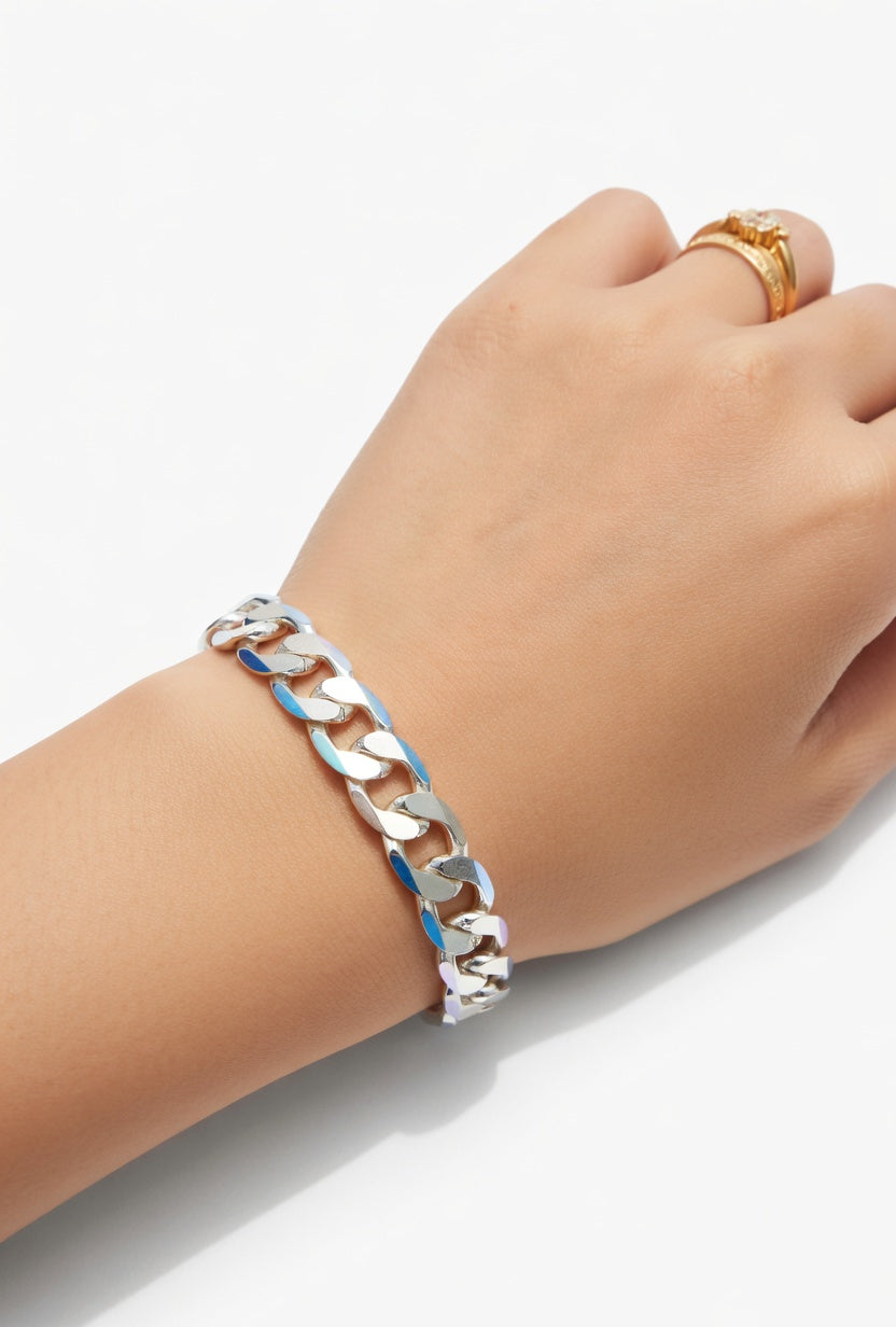Hand wearing a silver chain bracelet on a white background
