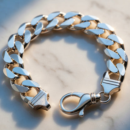 ilver chain bracelet with a clasp on a marble surface with sun shining