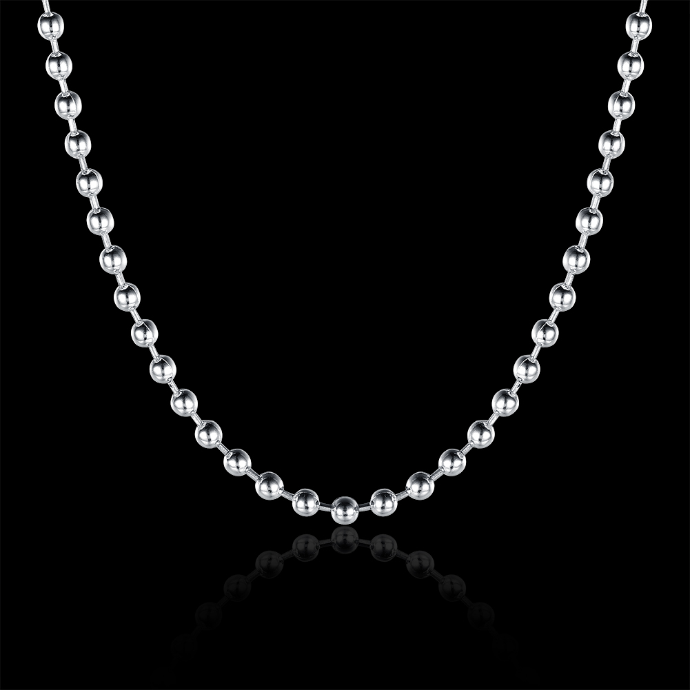 A silver ball chain necklace with polished metallic spherical links, displayed in a U-shape against a solid black background with a subtle reflection below.